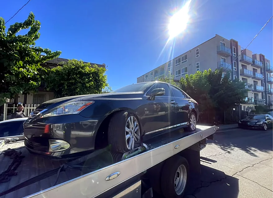 Curbside pickup: Sedan loaded and strapped at the curb