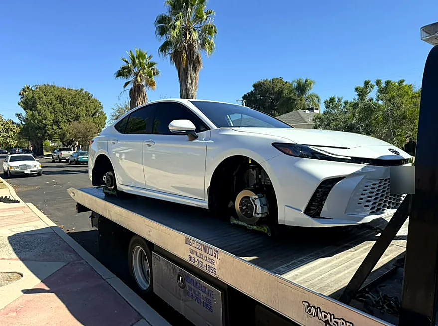 Strapped down: New sedan secured by its wheels